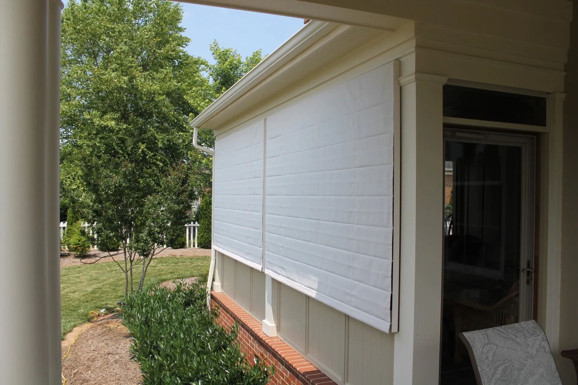 005 (2) The Sunbrella® Awning and Marine 6004 Natural exterior screen porch understated elegance reflects the fine eye of the homeowner.