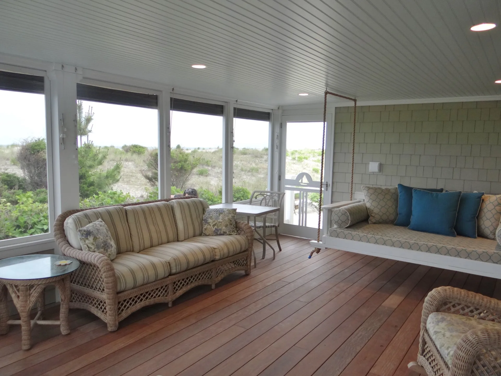 Shade completely lifted welcomes the seaside fresh air, while a hanging bed invites for an afternoon nap or evening sleep over.