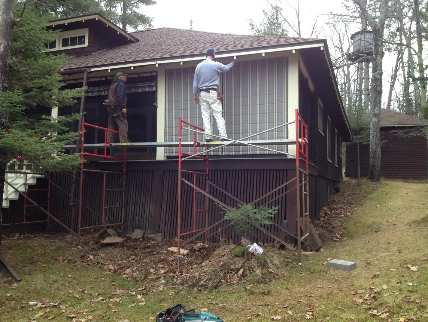 image10 Steve and son worked with Pete on the final step of installing the Weather Queen® Exterior Screen Porch System. The Sunbrella Awning and Marine Fabric 4768 Preston Stone looks right at home on this Lake Superior historic home.